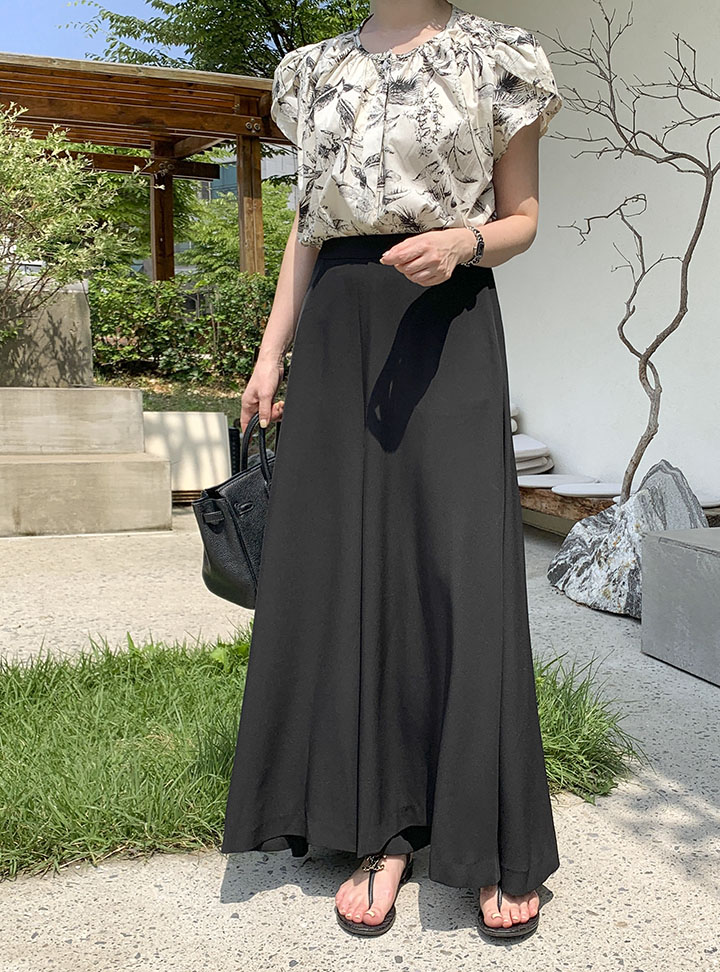 Black maxi skirt with a statement blouse for the office